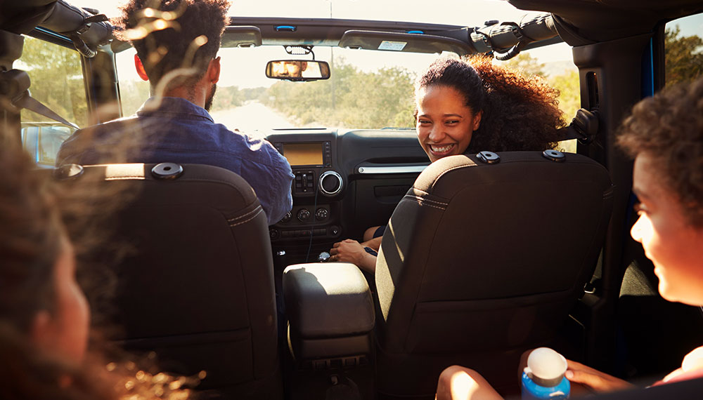 A family of 4 enjoying in the car together