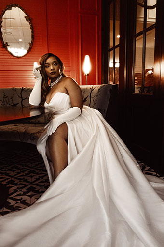 bride sits in booth at King Brasserie restaurant at Kimpton Hotel Fontenot