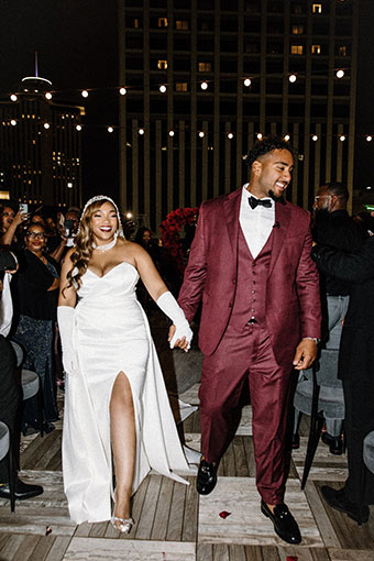 bride and groom hold at at wedding reception on King Terrace at Kimpton Hotel Fontenot