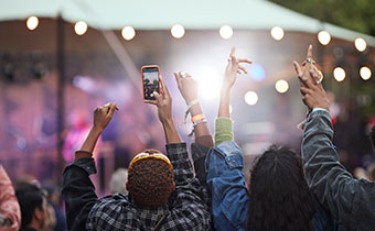 young people with arms raised in the air